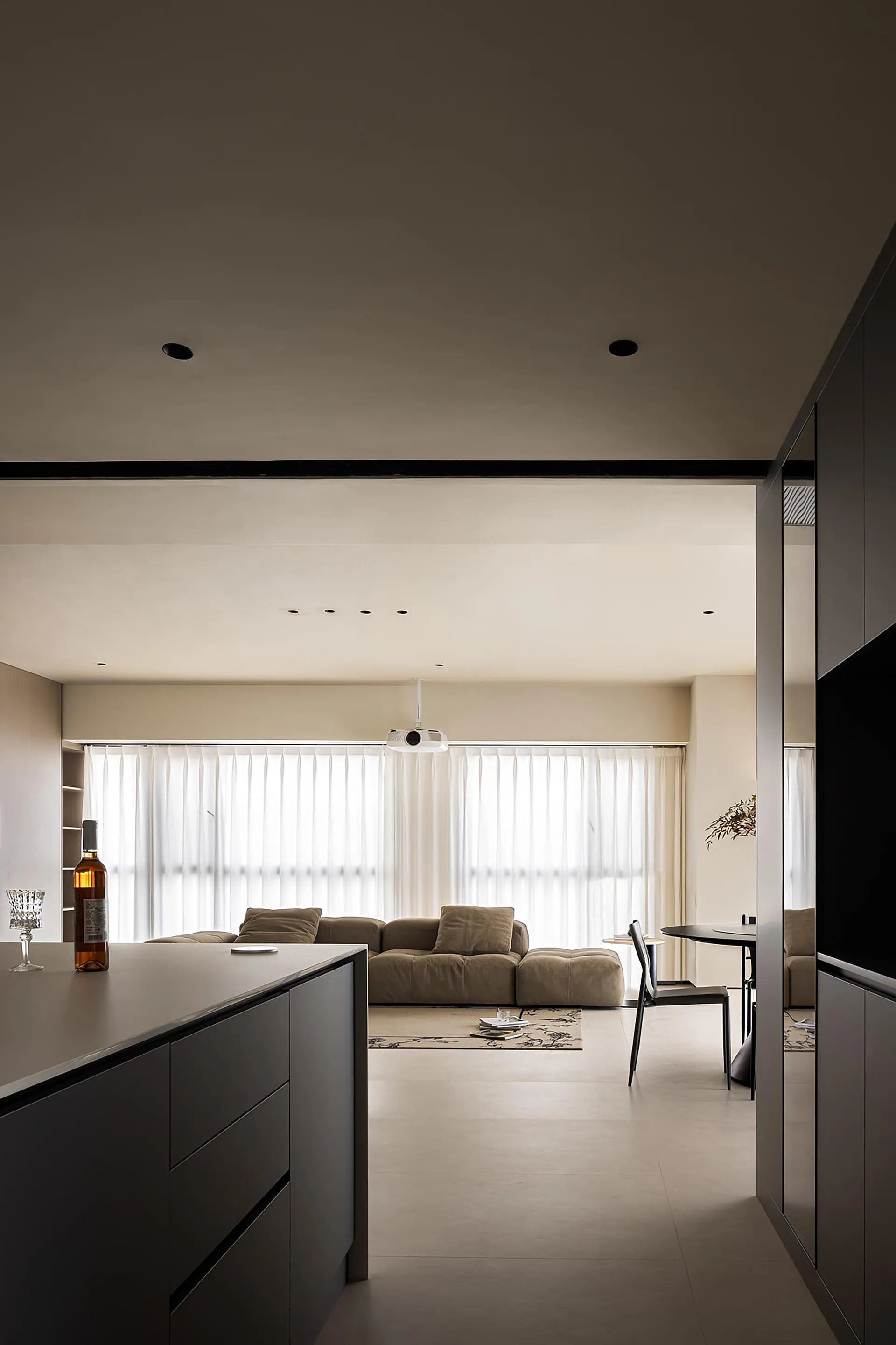 Modern minimalist living room with neutral color palette and open concept floor plan.