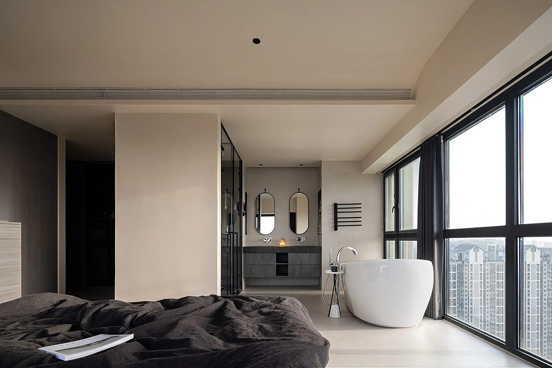 Modern residential interior with a bathtub and a view of the city.