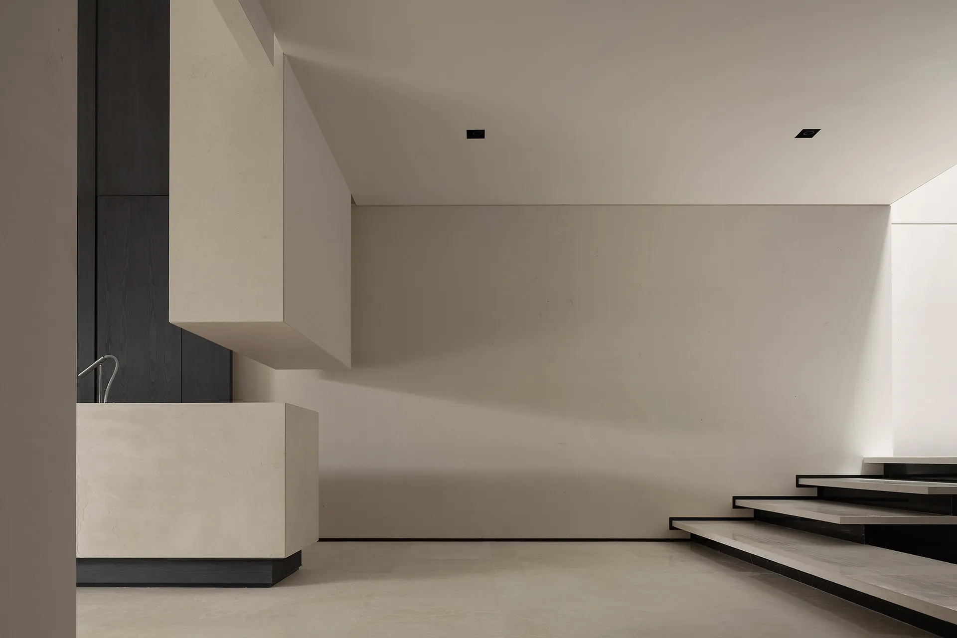 A minimalist, contemporary stairwell with a concrete finish and clean lines.