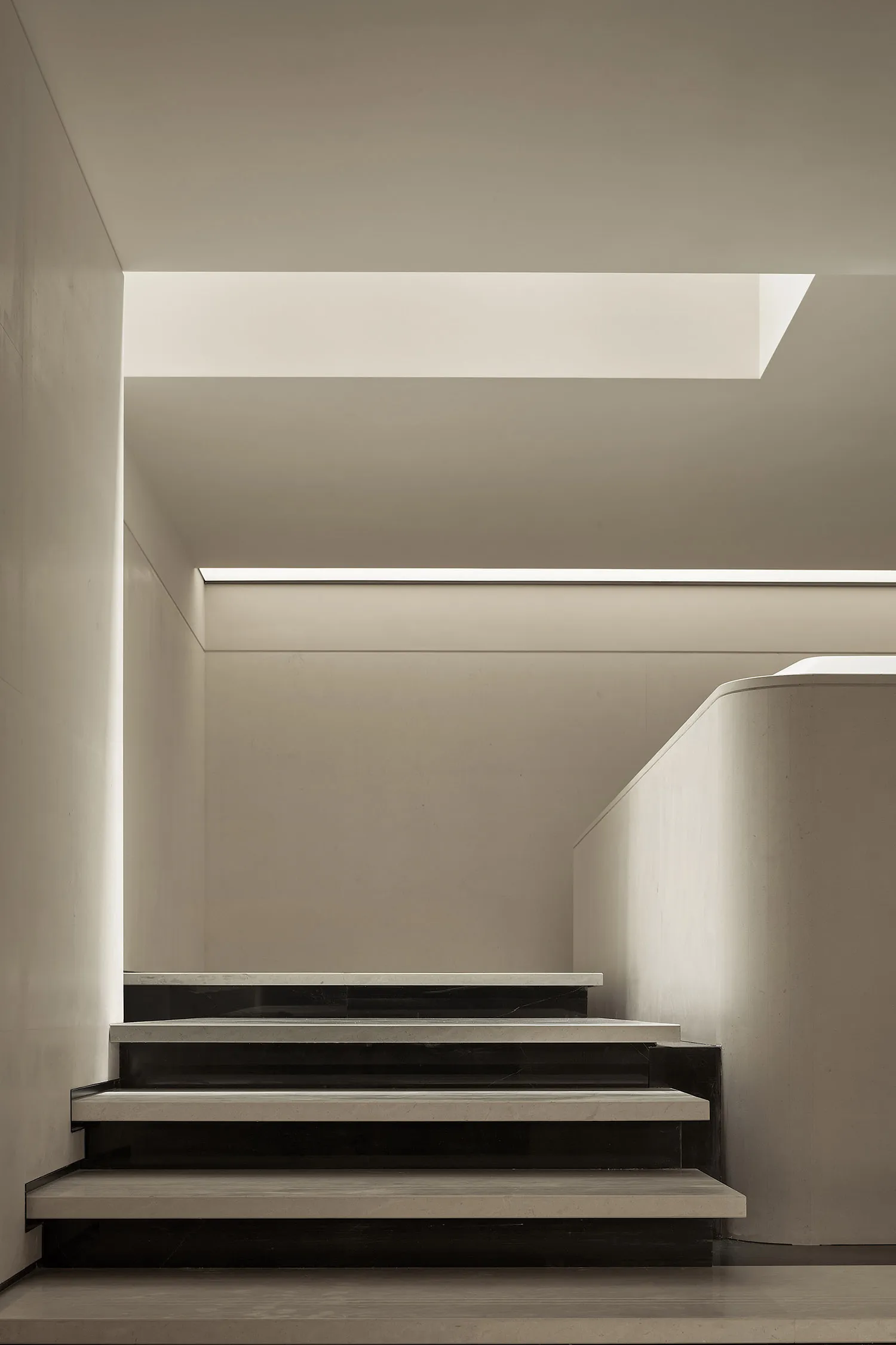Modern minimalist stairs made of concrete and marble materials.