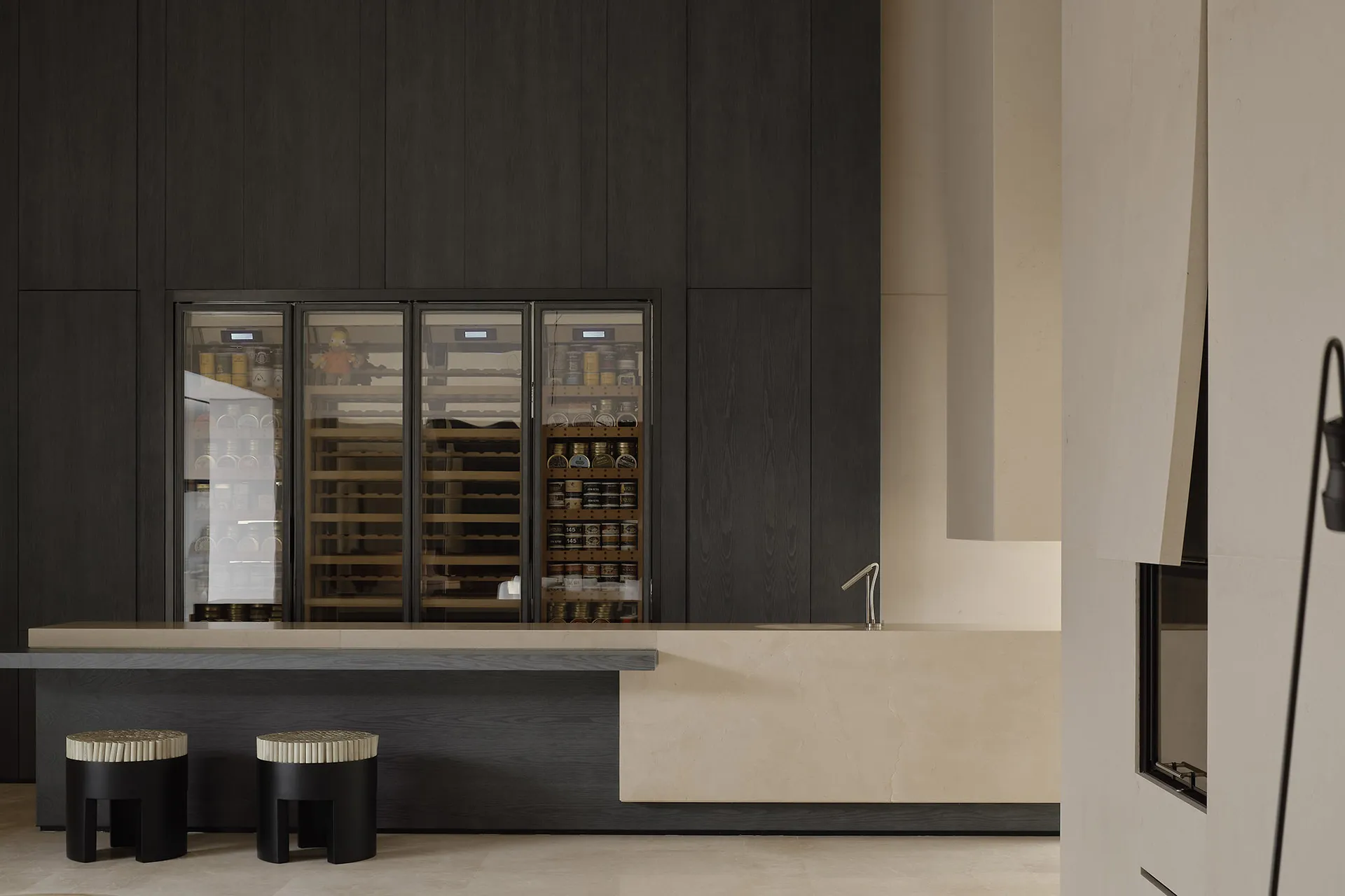 A modern minimalist mini kitchen with marble countertops and dark wooden cabinets.