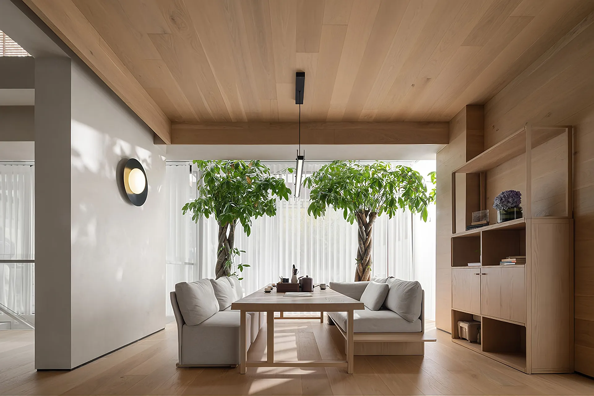Modern minimalist living room with wooden furniture and trees