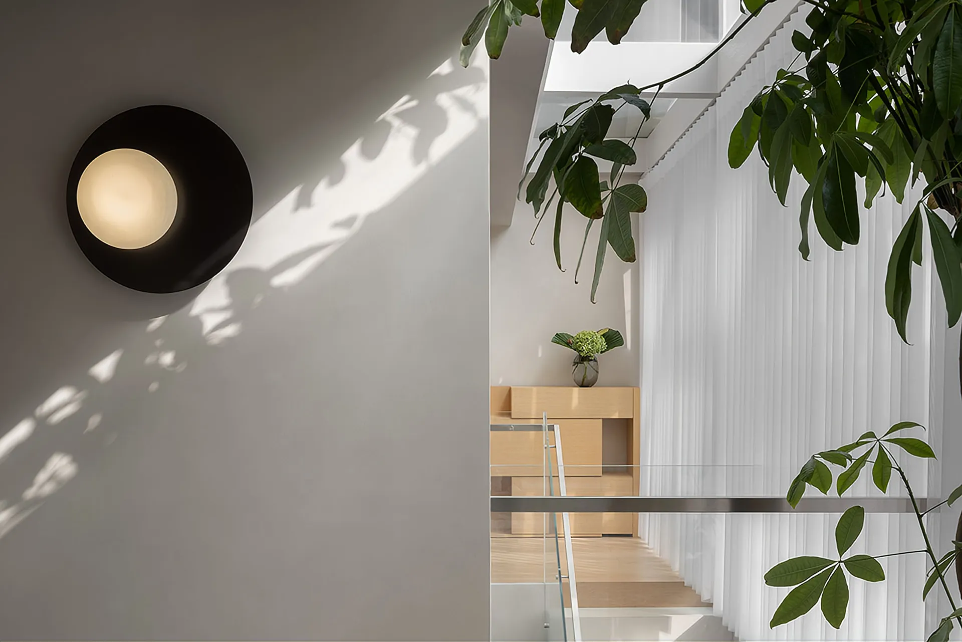 Modern residential interior featuring glass and steel materials.