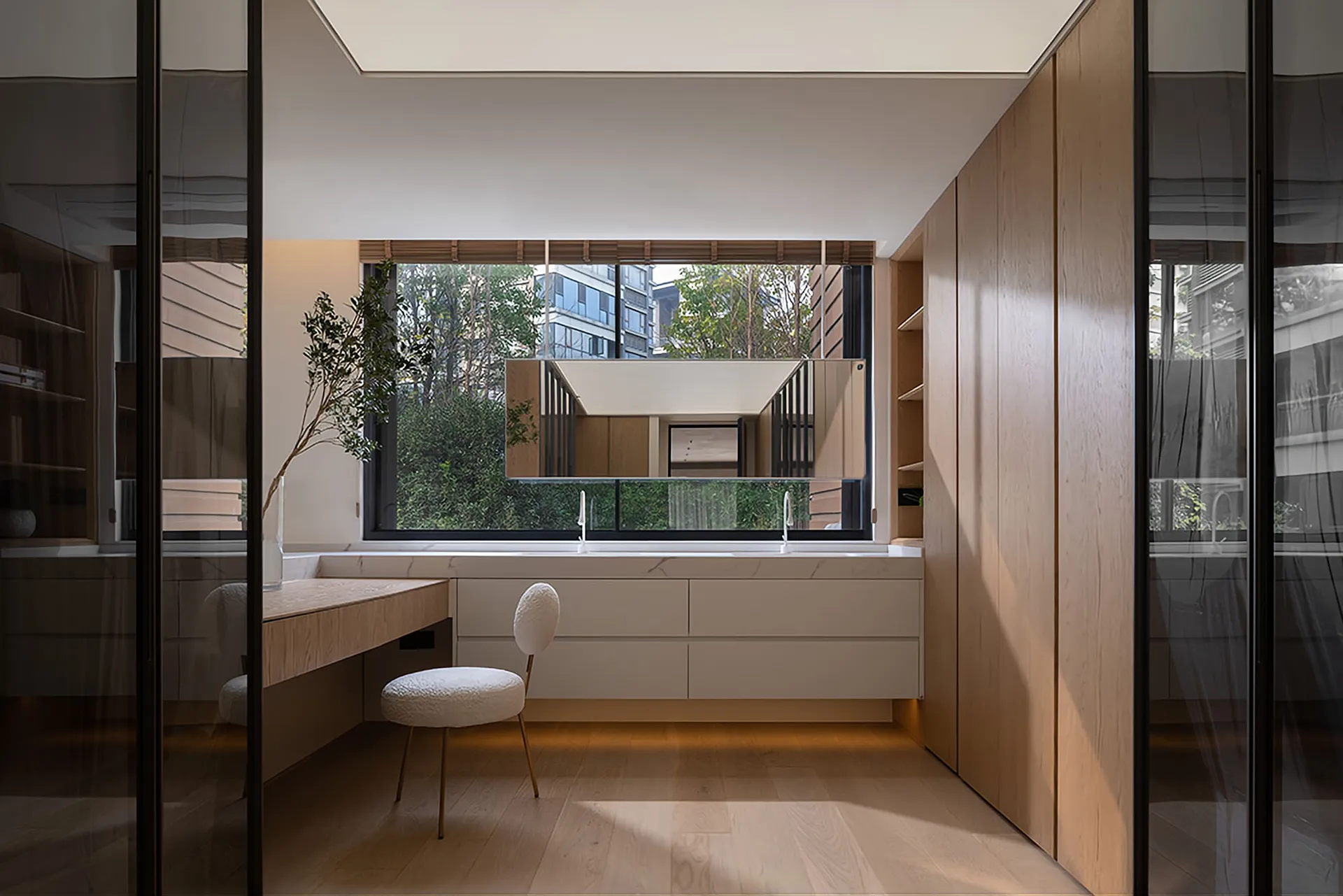 Modern minimalist bathroom vanity with a window, featuring clean lines and a sleek design.