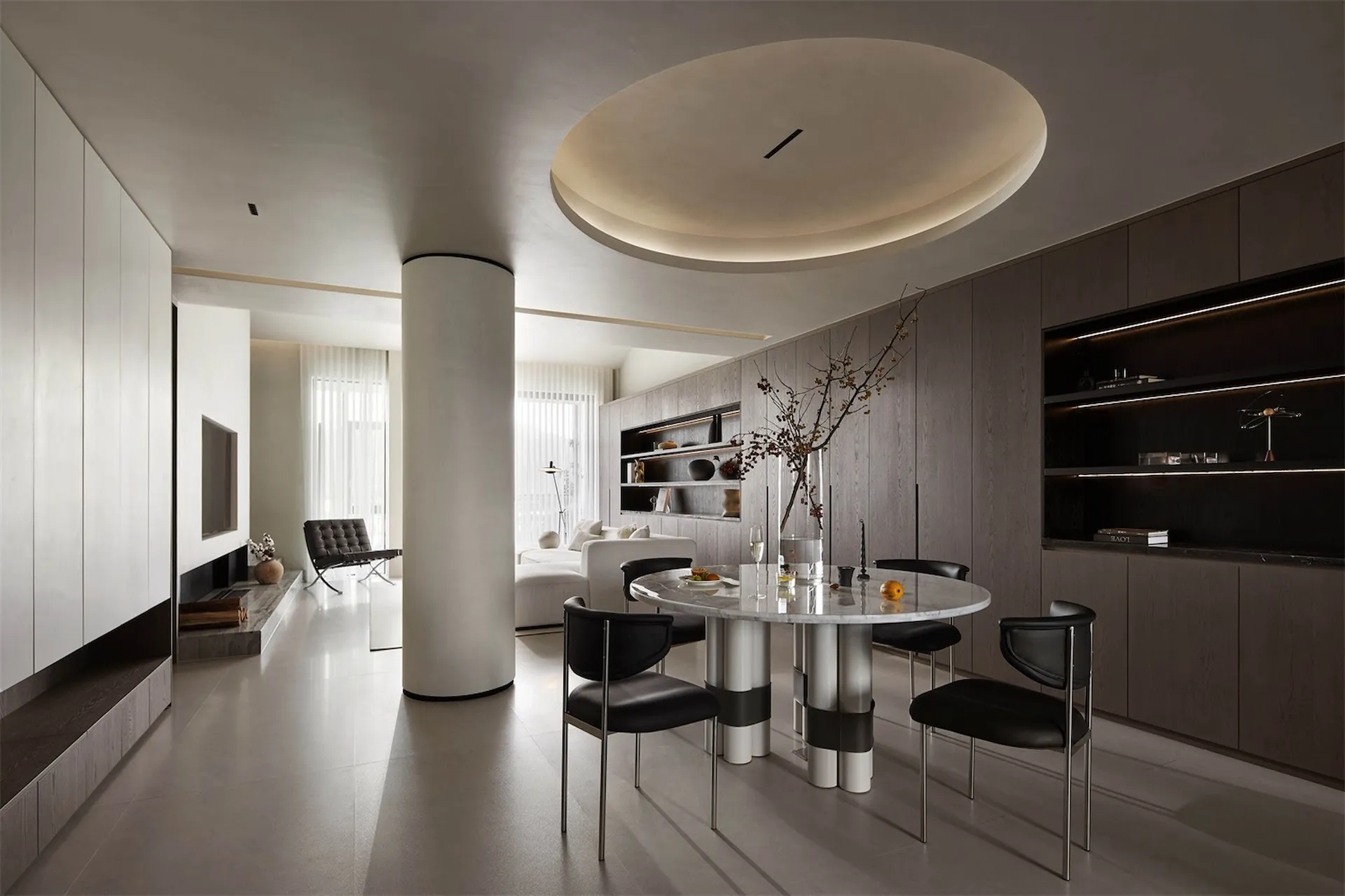 Modern dining room featuring a marble dining table, metal chairs, and wooden accents.