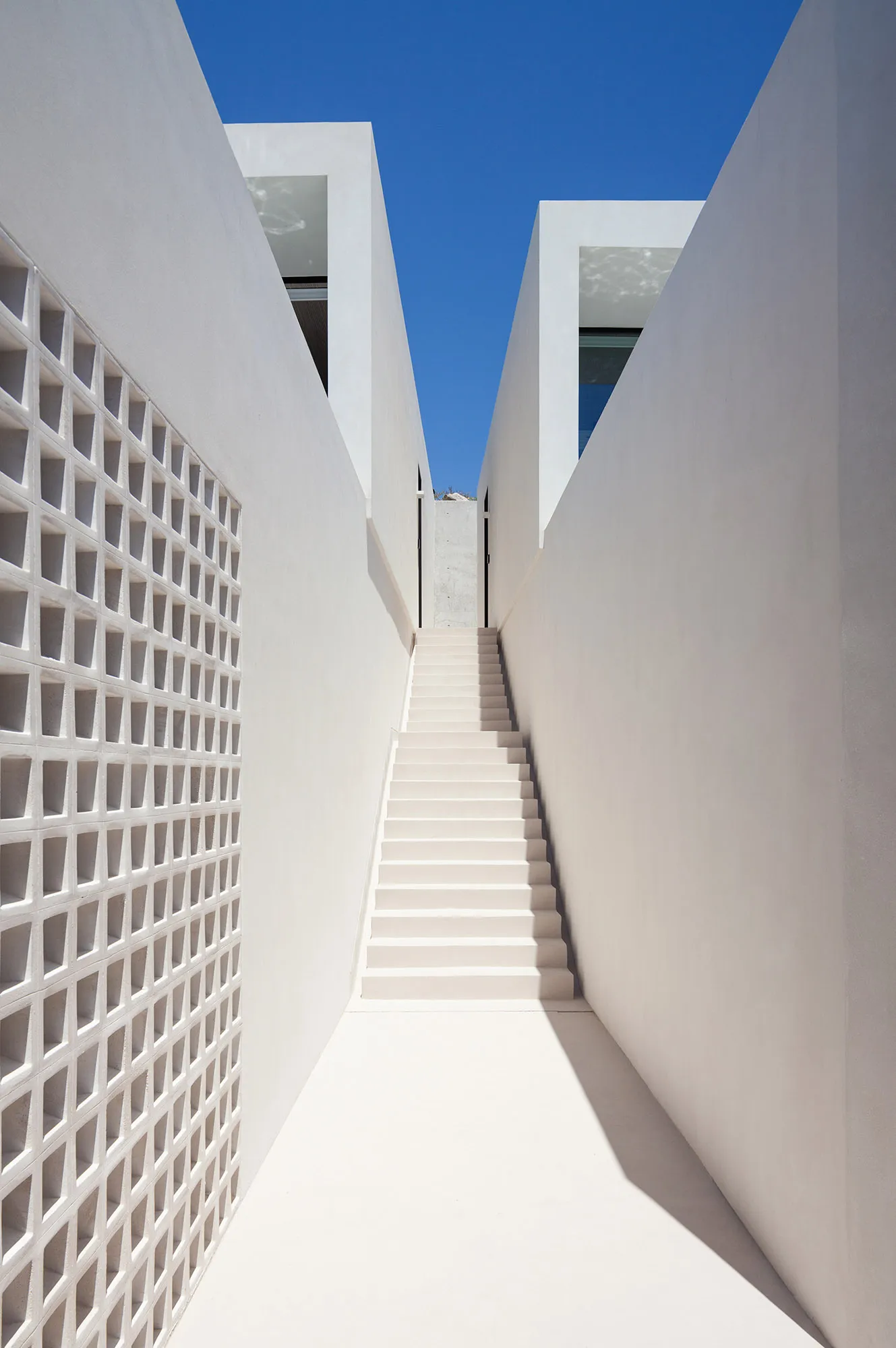 Concrete staircase with minimalist design, leading upwards.