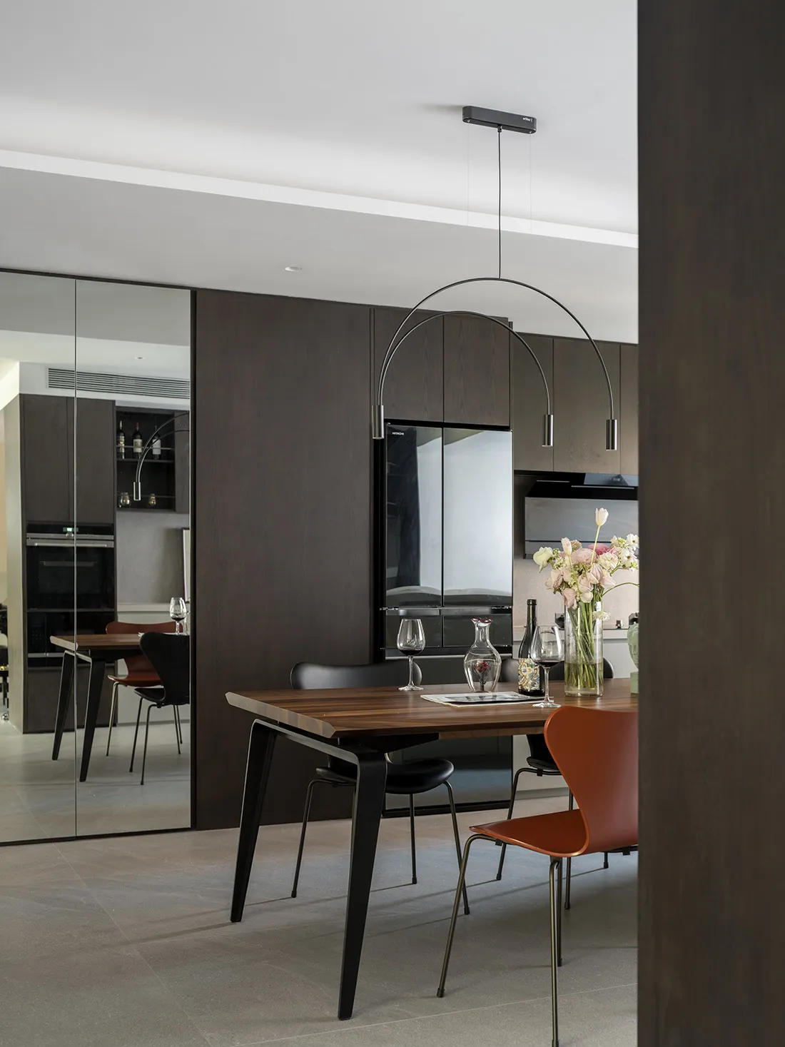 Modern minimalist kitchen with wooden table, metal chairs, and minimalist decor.
