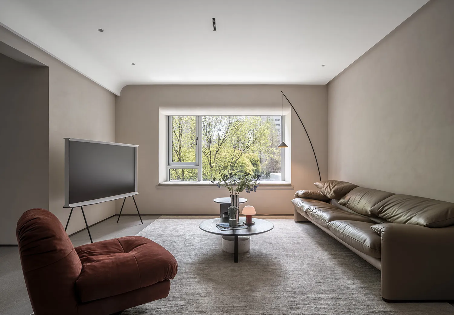 Contemporary minimalist living room with modern furniture and neutral color palette.