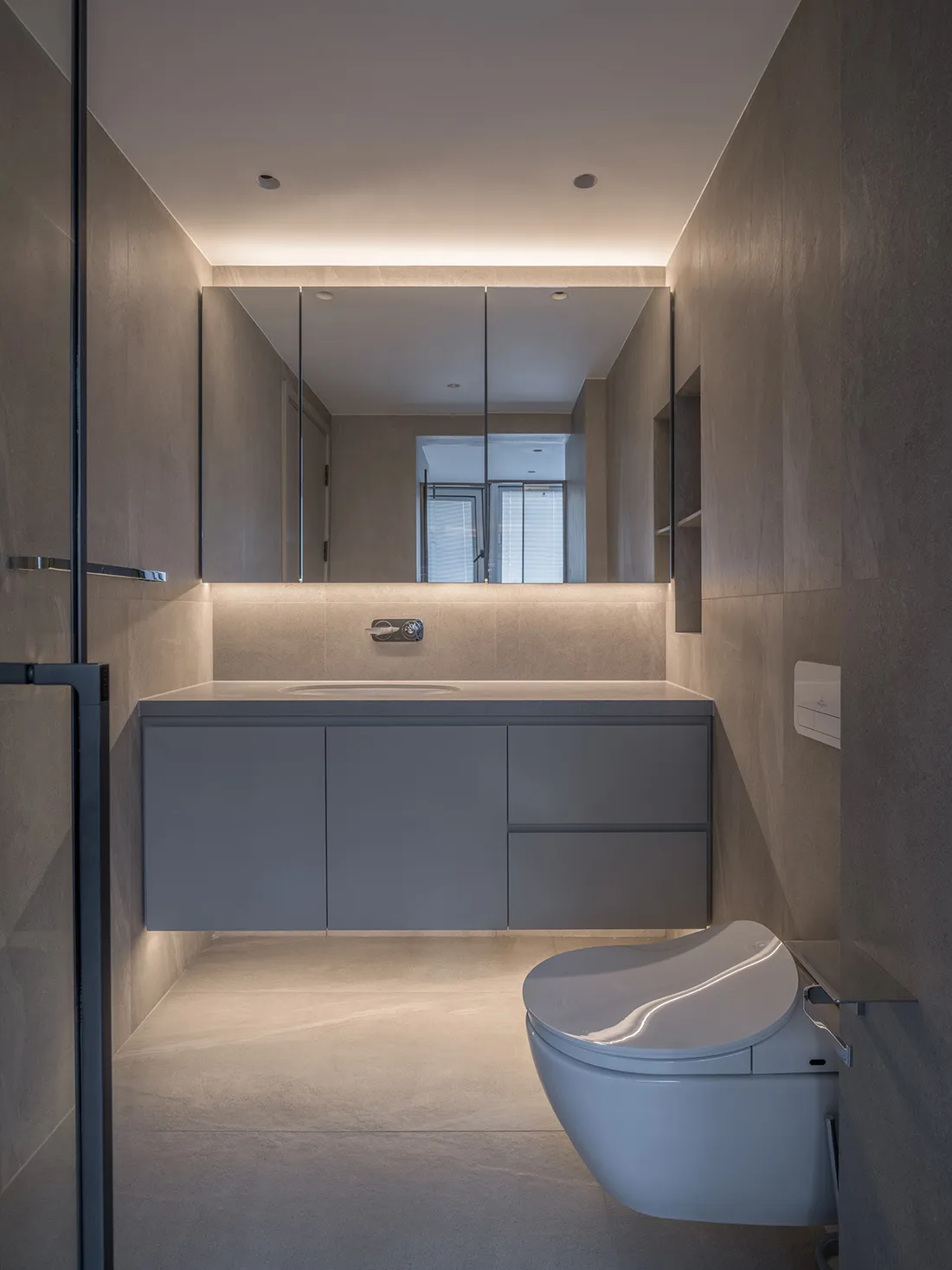 Modern minimalist bathroom with ceramic fixtures and sleek design.