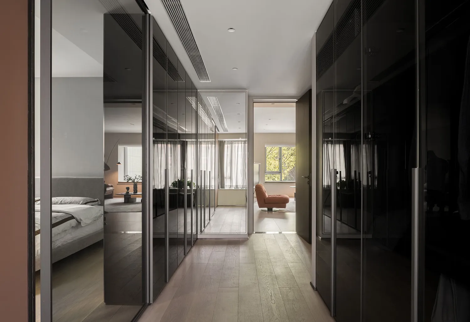 Modern residential interior featuring glass doors and wooden flooring.