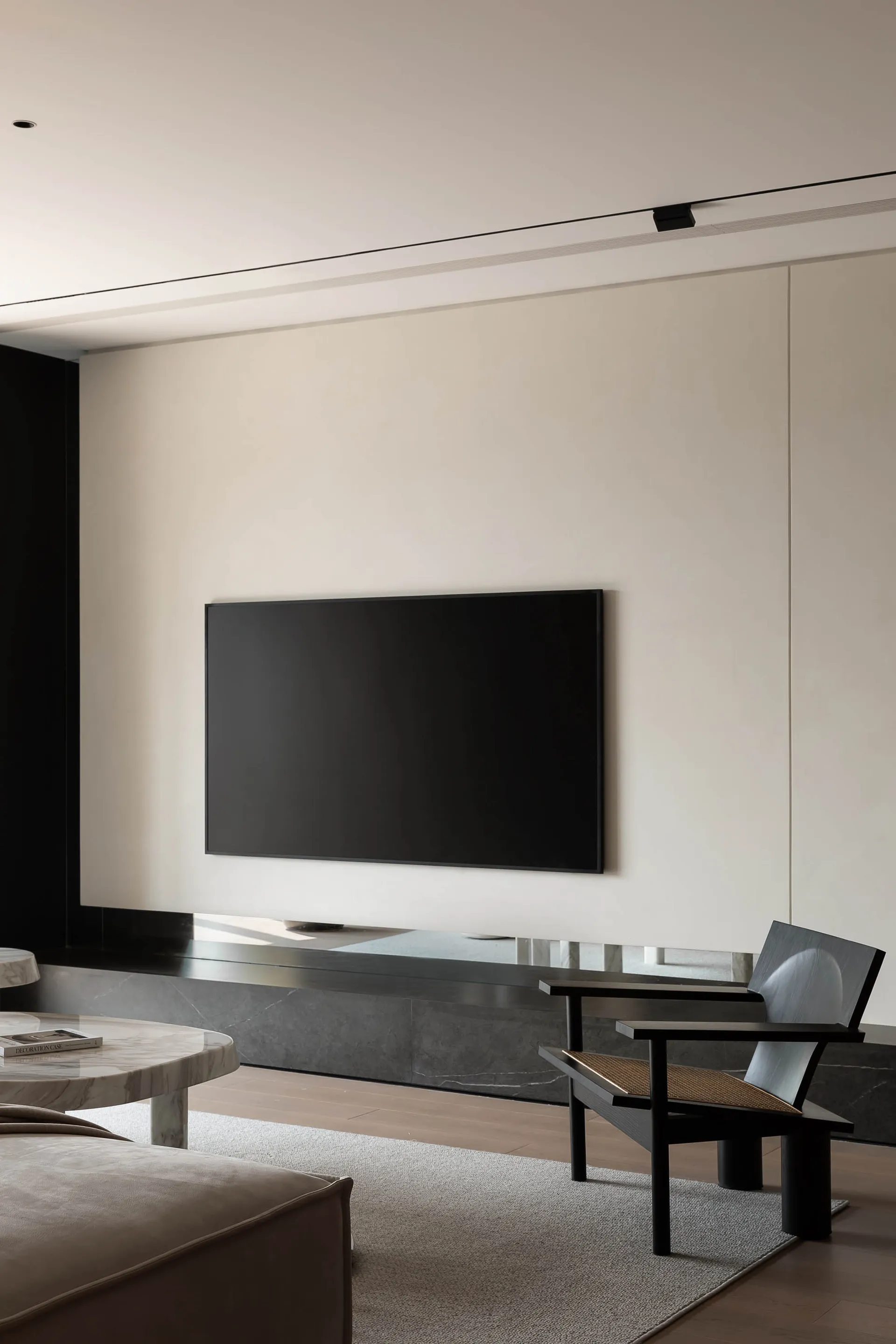 Modern minimalist living room featuring marble, metal, and wood elements.