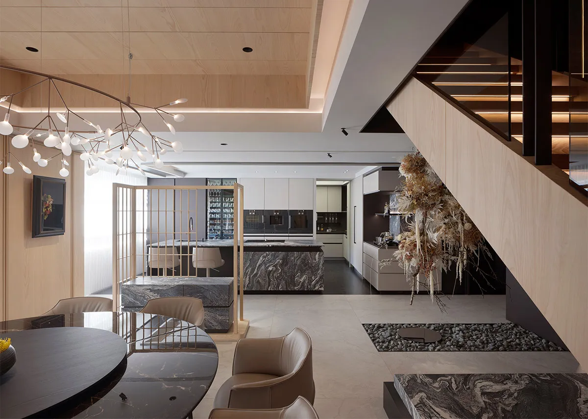 Modern residential kitchen featuring marble countertops and walls, with a contemporary design and minimalist aesthetics.