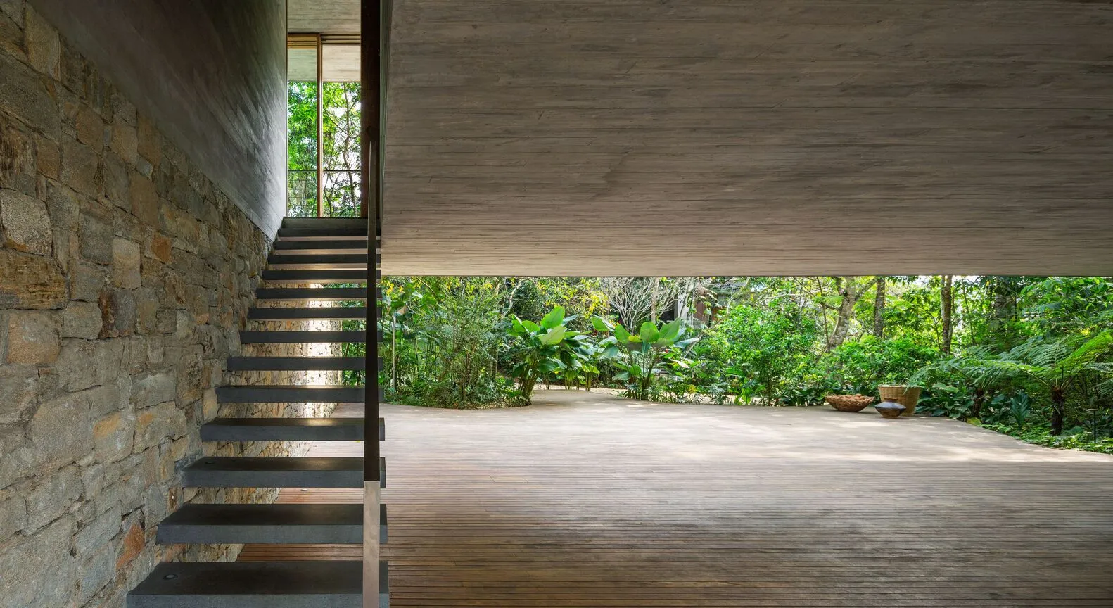 A modern interior space featuring stone and concrete materials.