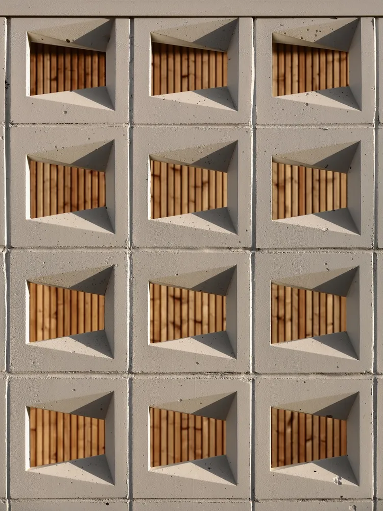 Modern architectural design featuring concrete blocks arranged in a geometric pattern.