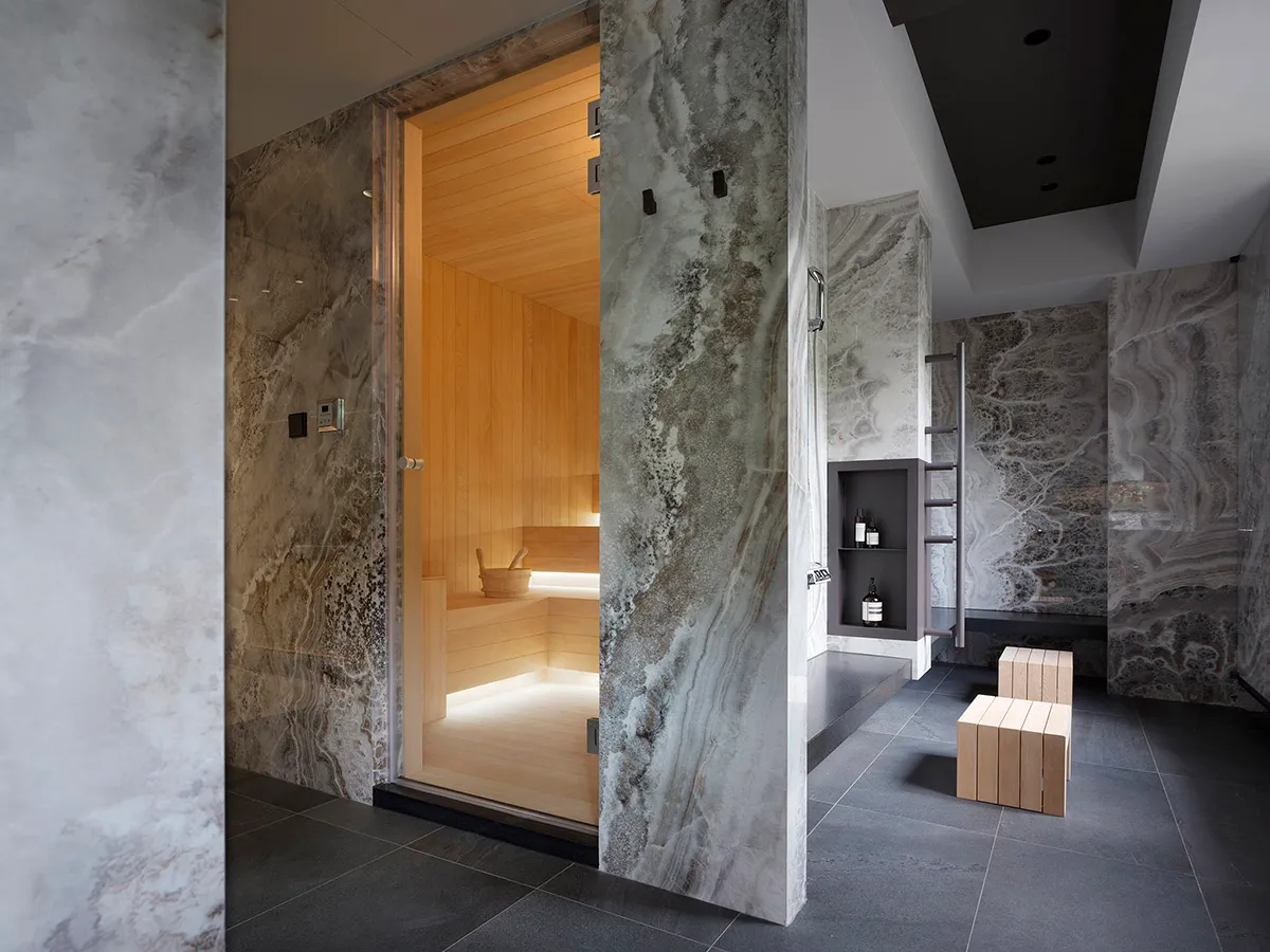 A modern spa interior with marble walls and wooden accents.