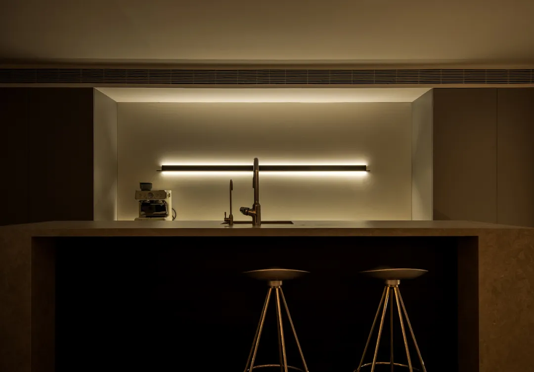 A modern kitchen with a concrete countertop and minimalist design.