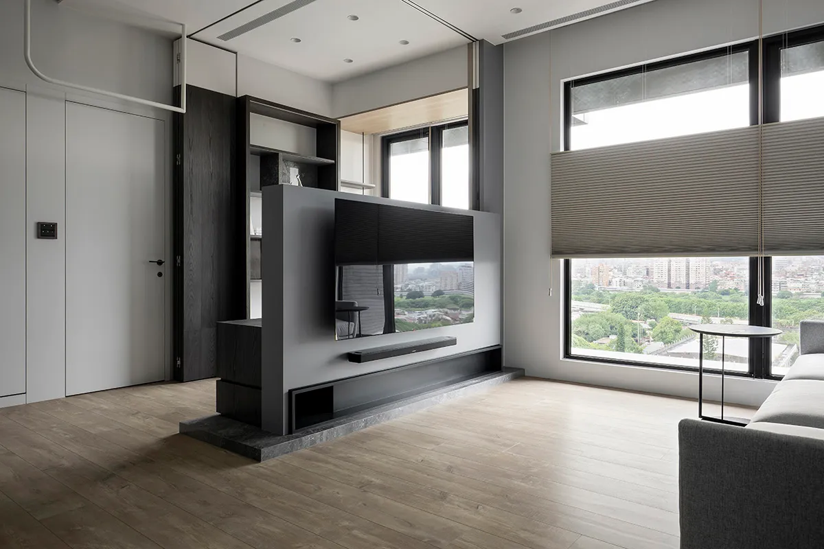 A modern living room featuring metallic elements and wooden flooring and furniture.