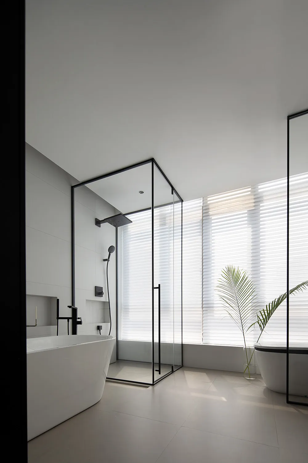 Modern, minimalist bathroom featuring glass walls and white fixtures.