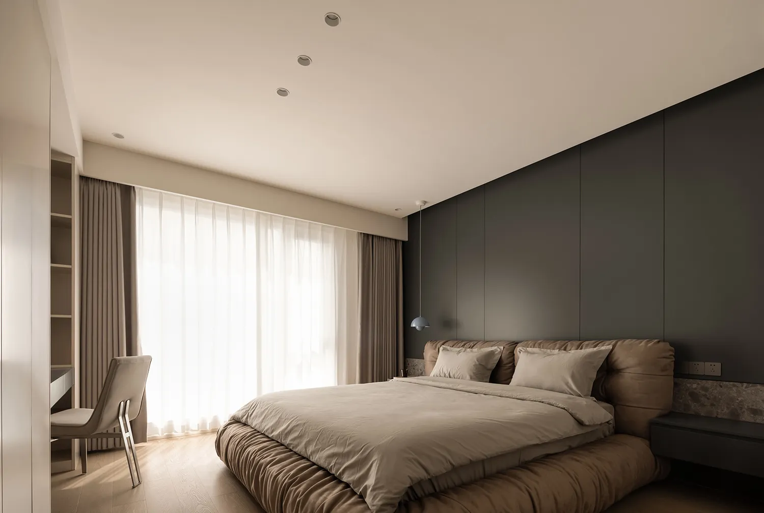 A minimalist bedroom with a taupe-colored bed and curtains.