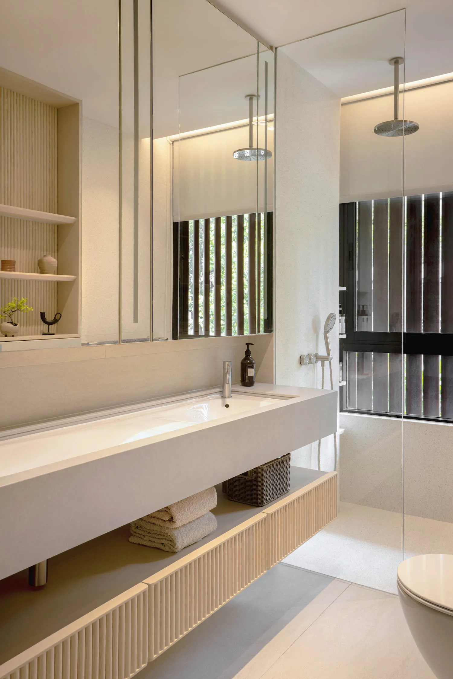 Modern bathroom interior with sleek concrete walls, minimalist design, and a vanity with a floating sink and shelves.