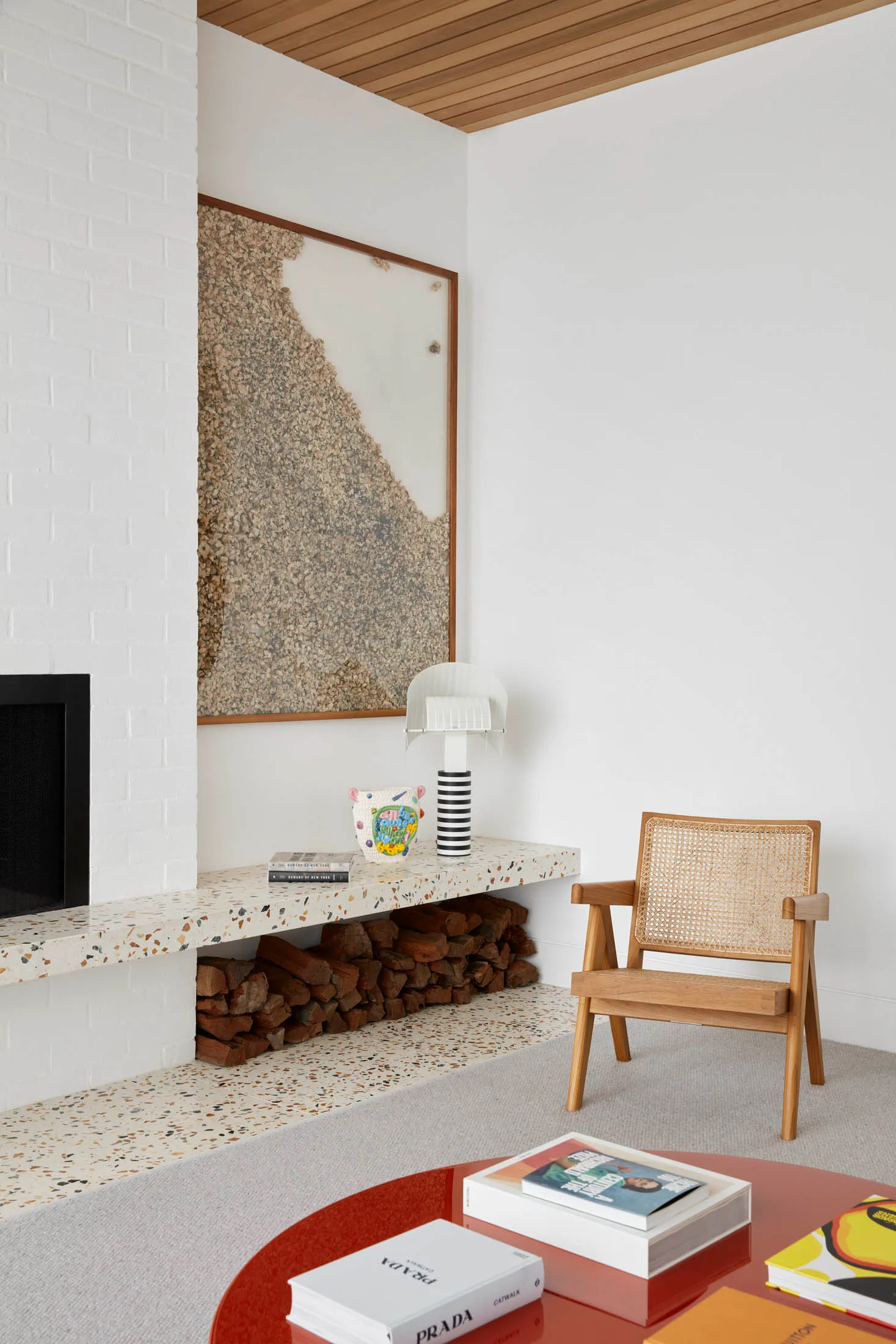 A modern living room featuring a contemporary terrazzo floor, wooden furniture, and concrete elements.