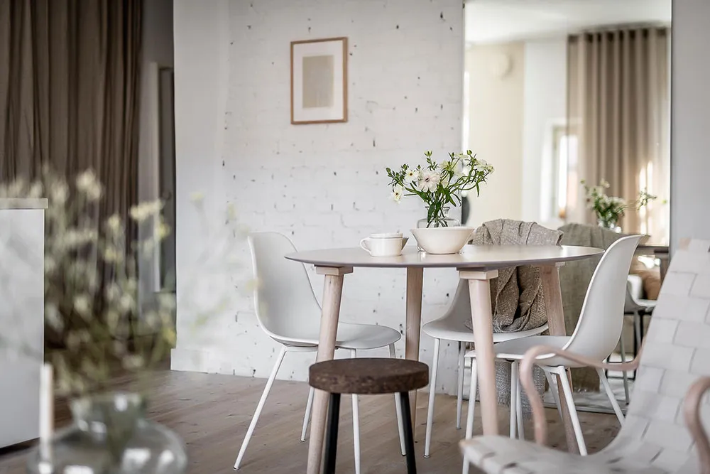 Modern dining room featuring minimalist furniture and wooden elements