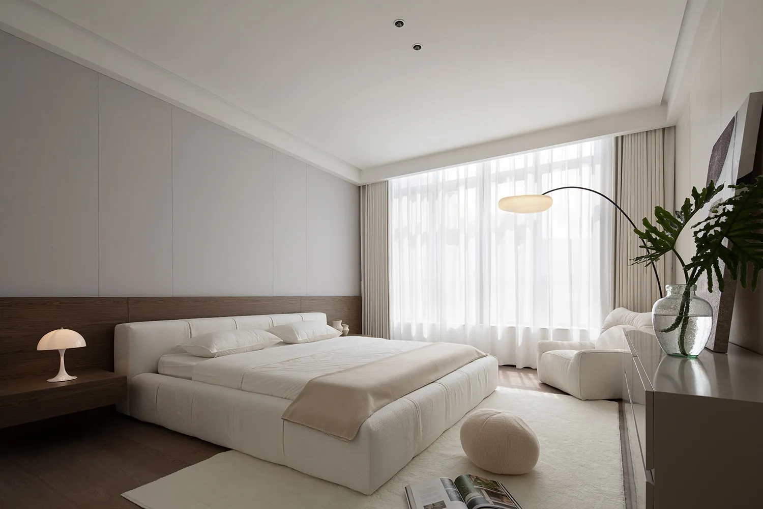 A modern minimalist bedroom featuring a white bed, textured fabric, and white curtains with a sleek floor lamp.