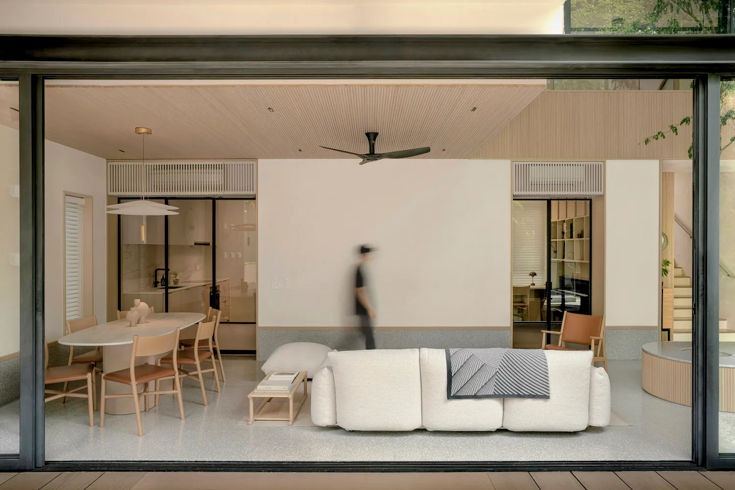 A minimalist living room with terrazzo flooring.