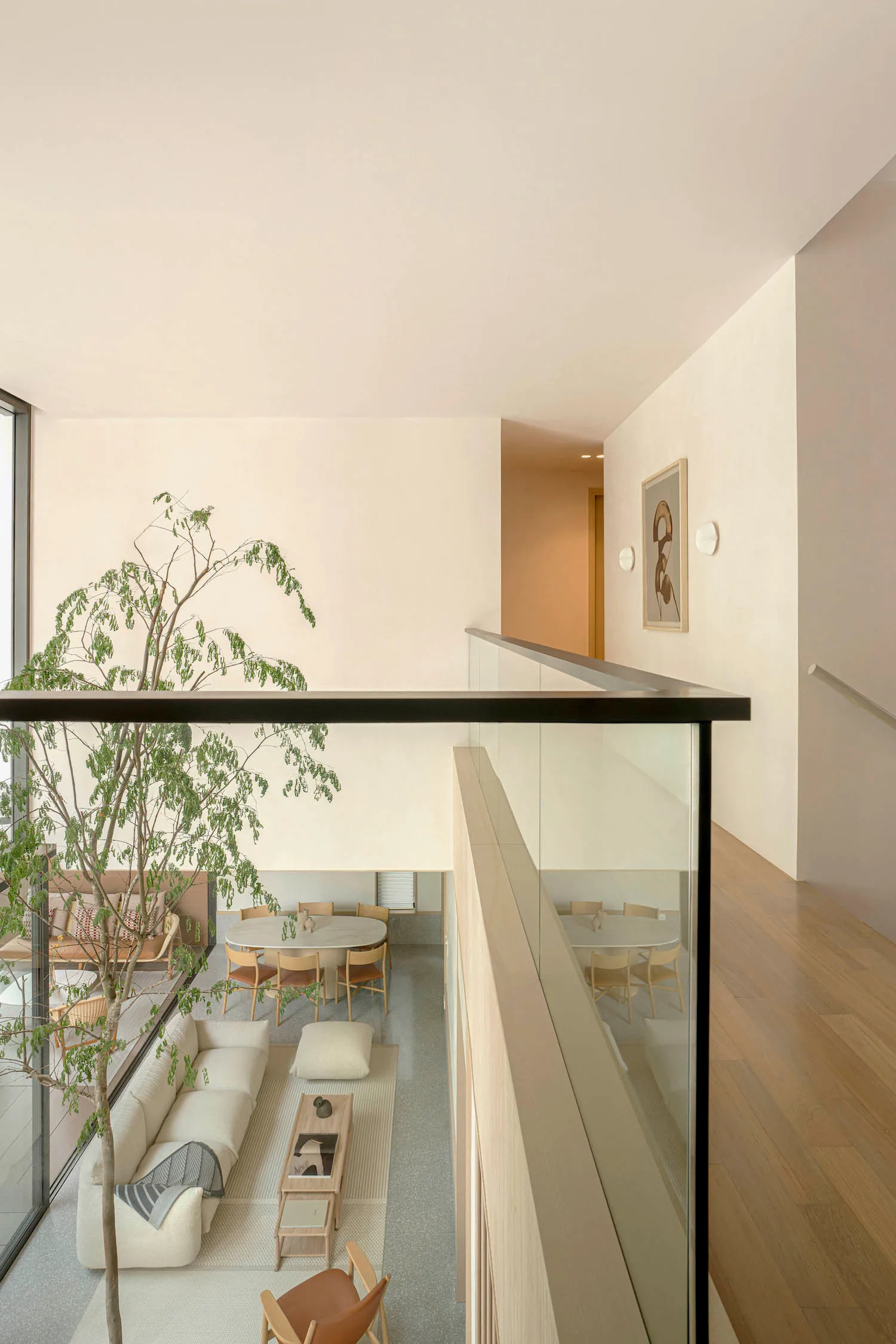 A minimalist living space showcasing a terrazzo floor and furniture.