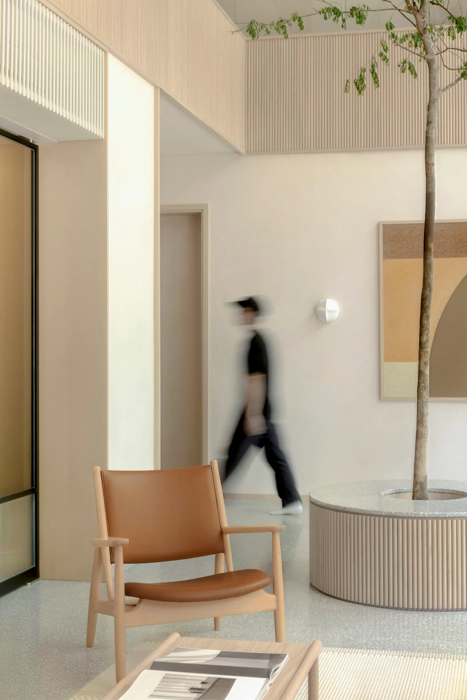 A modern lobby with terrazzo flooring and a minimalist design.