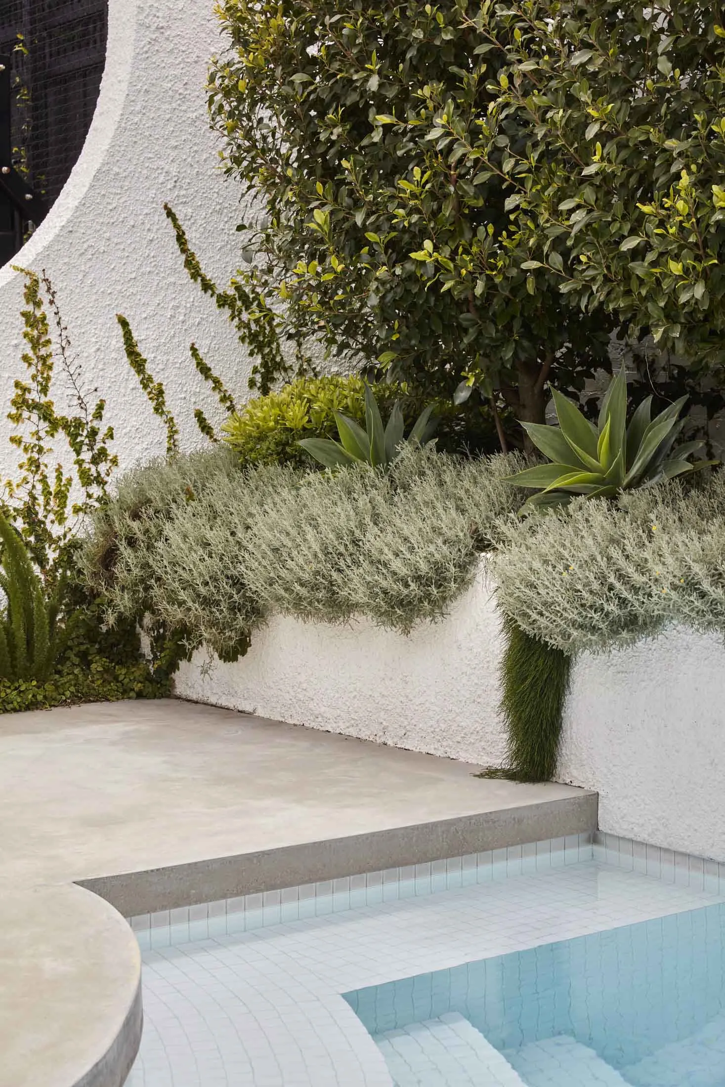 Modern minimalist outdoor retreat featuring concrete and tile surfaces.