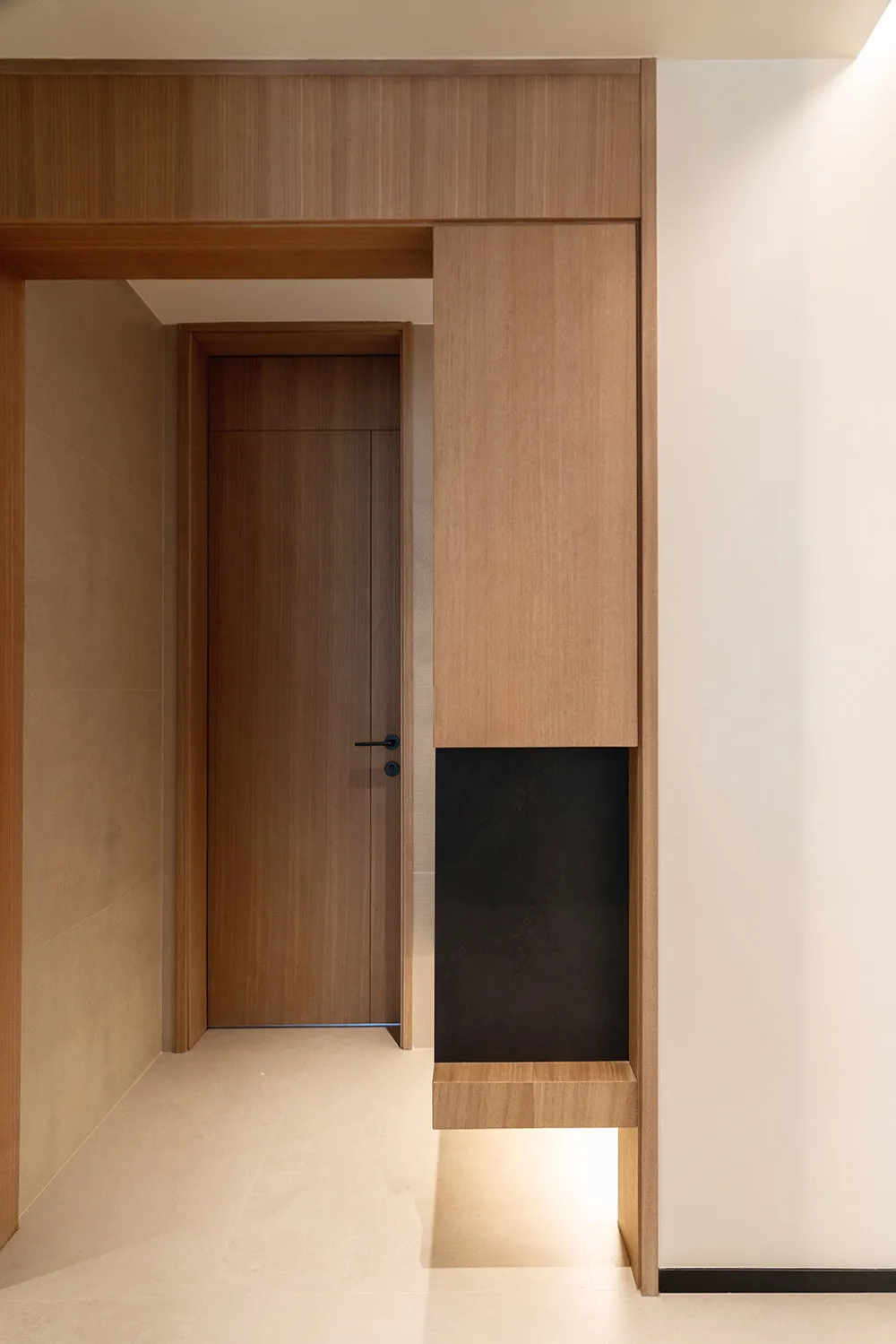 Modern minimalist interior design featuring a wooden entryway with glass elements.
