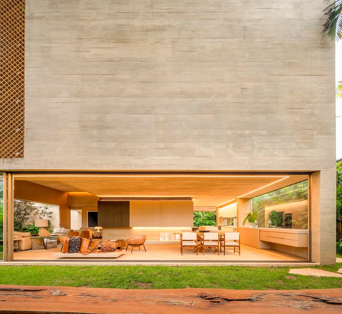 Modern living space with concrete walls and a warm, inviting interior.