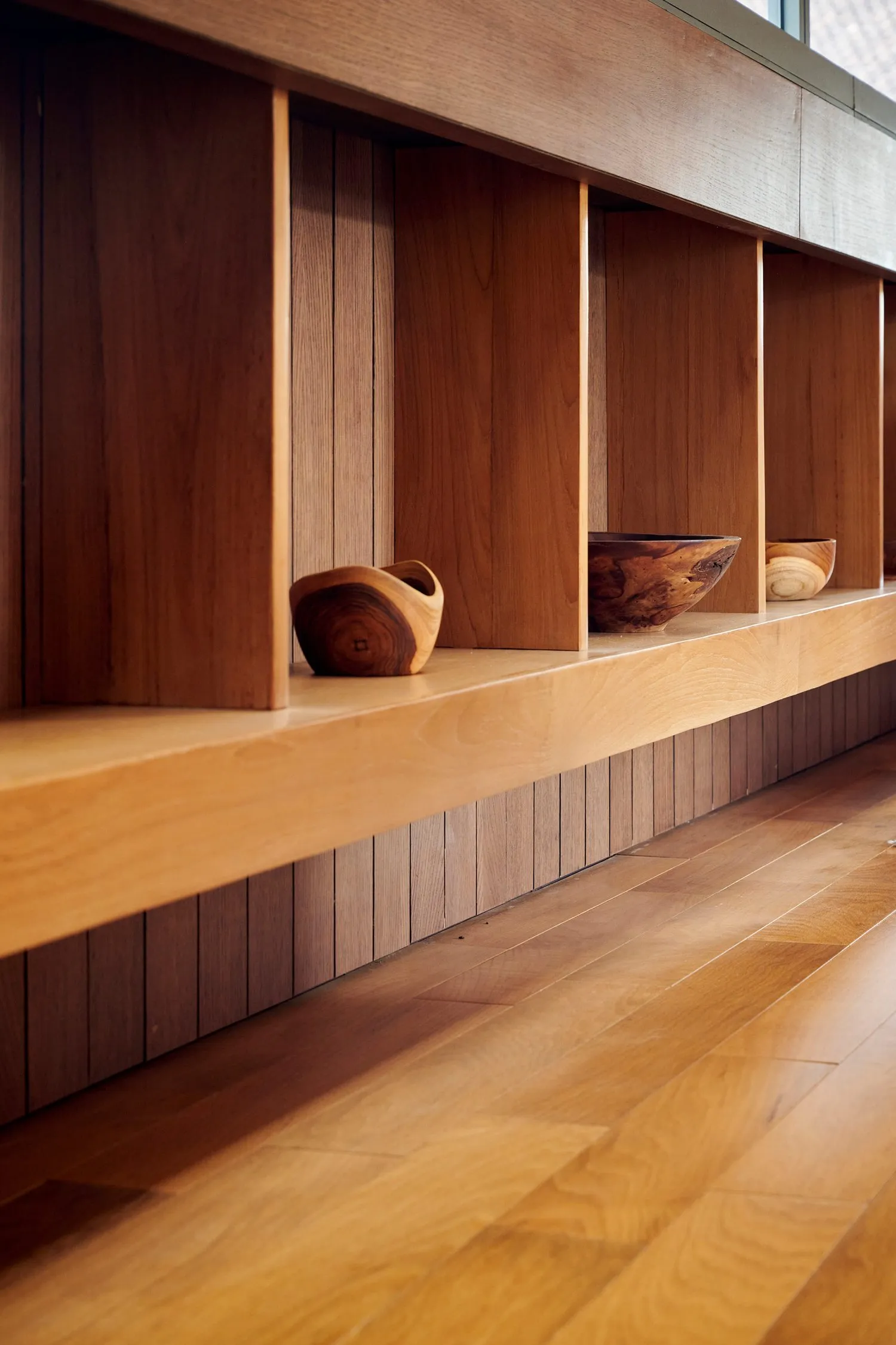 A minimalist living room showcases sleek, modern wood furniture.