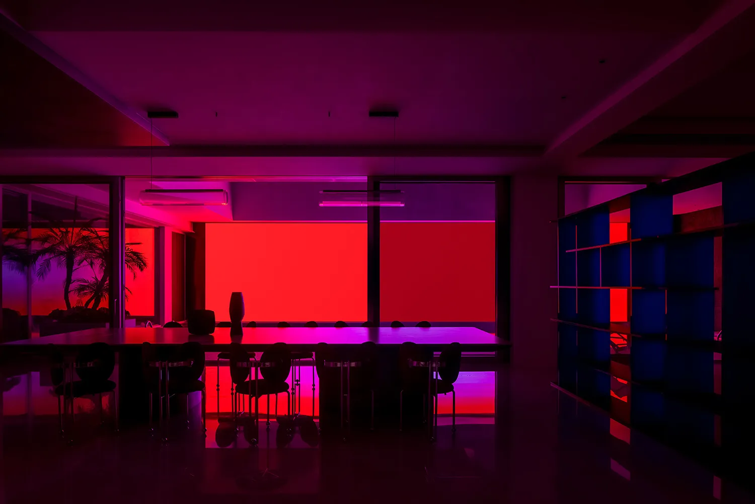 Modern conference room with purple lighting and metallic furniture.