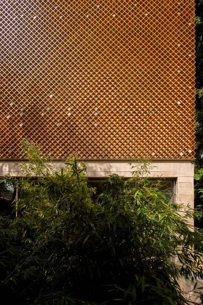 A diamond-patterned wooden facade of a building, featuring a lattice-like design.