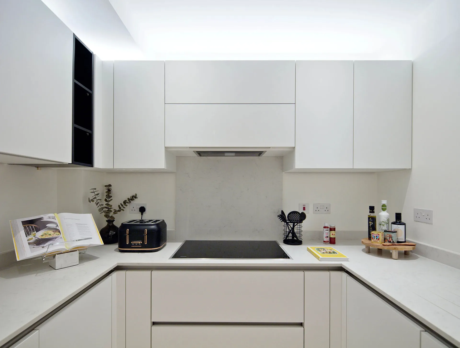 Modern, white kitchen cabinets with a minimalist design.