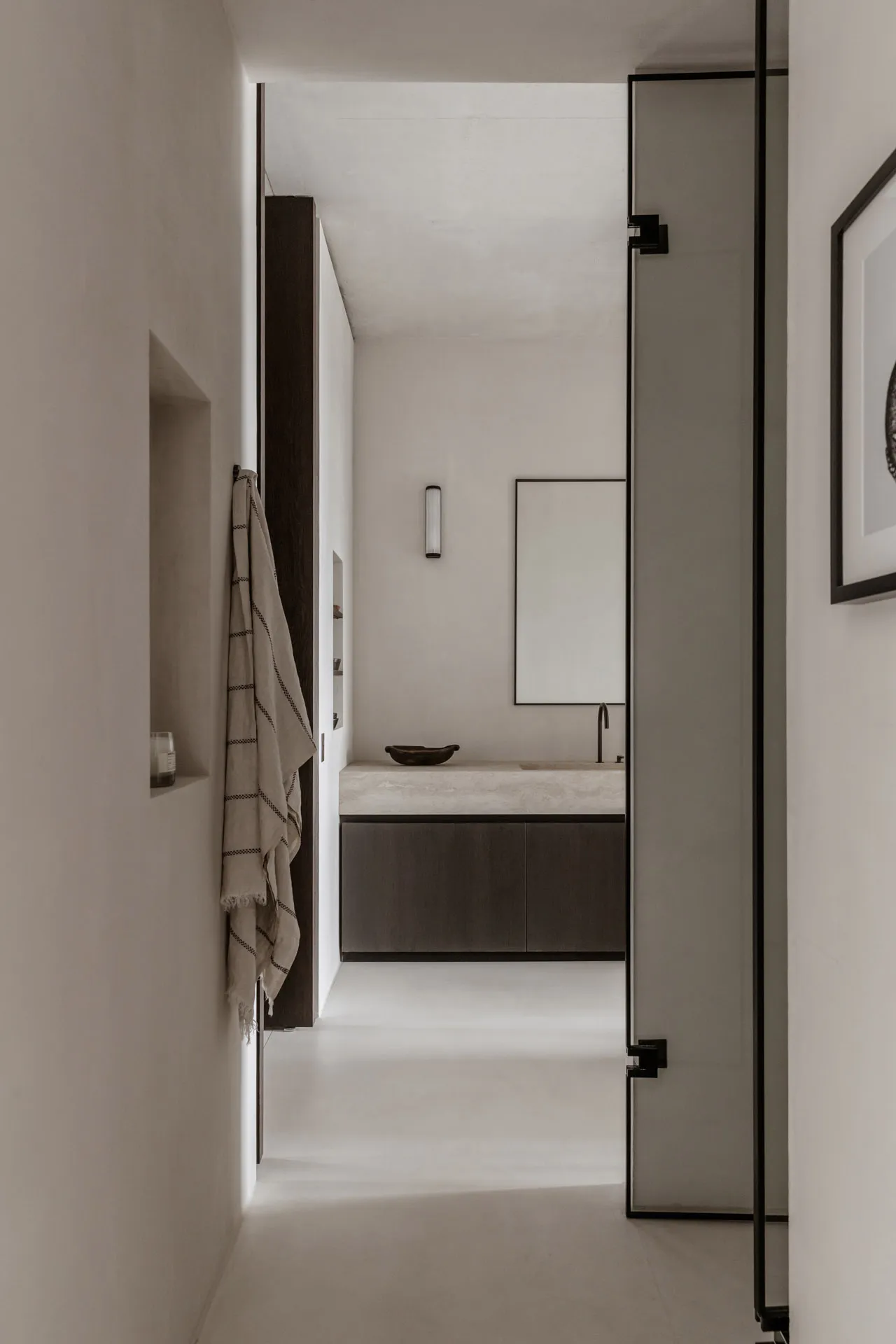 Modern bathroom with concrete surfaces and minimalist design.