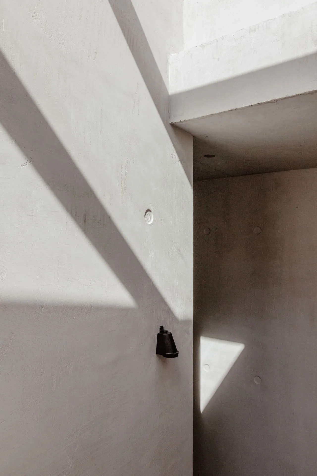 Modern minimalist interior with clean concrete walls and geometric forms