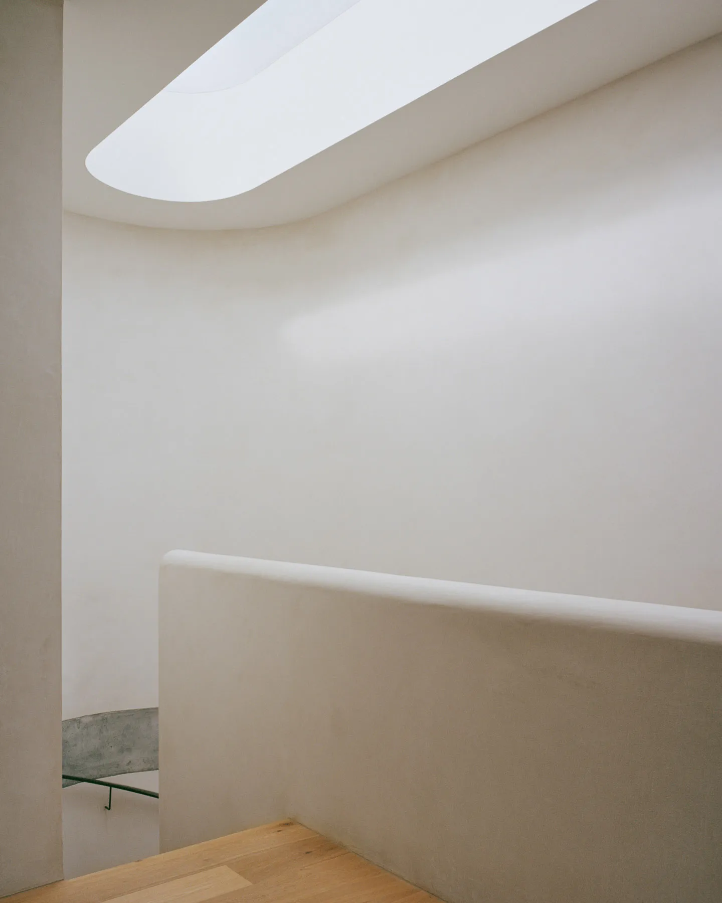 A minimalist modern interior space featuring a concrete wall and floor.