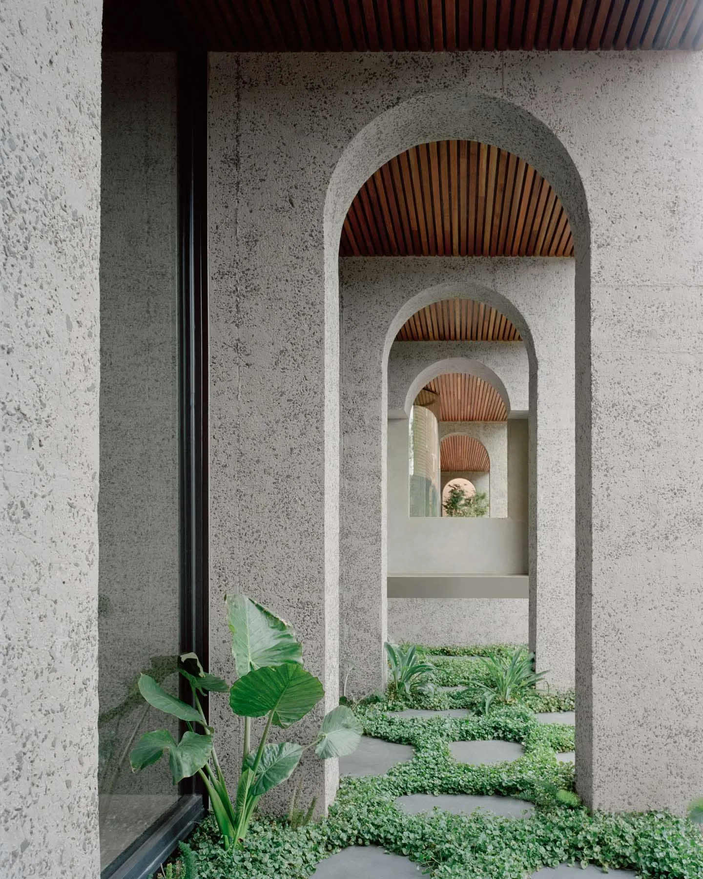 Architectural details of a modern building featuring concrete walls and arches.