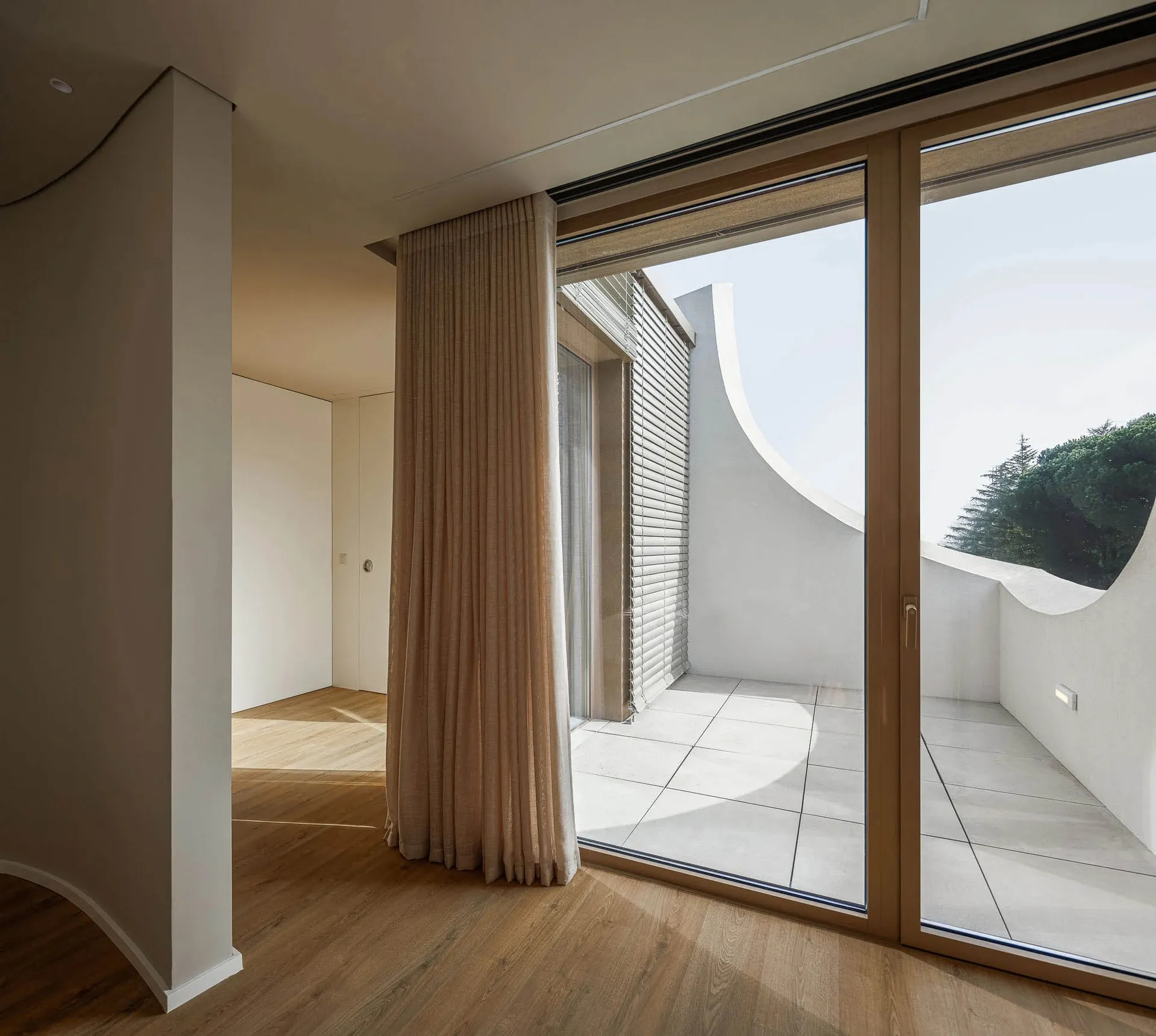 Modern interior design featuring a combination of wood, glass, and concrete materials.