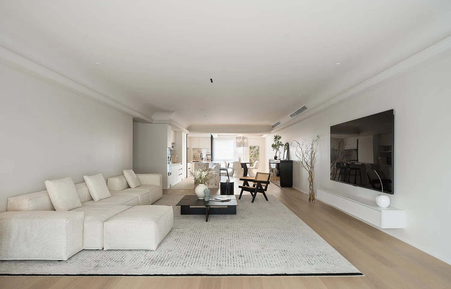 A modern minimalist living room with a neutral color palette.