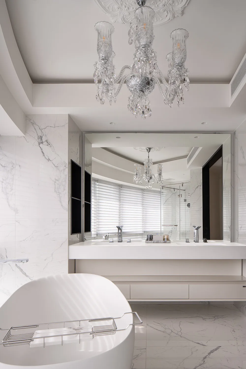 A sleek, modern bathroom designed with pure white marble and minimalist features.