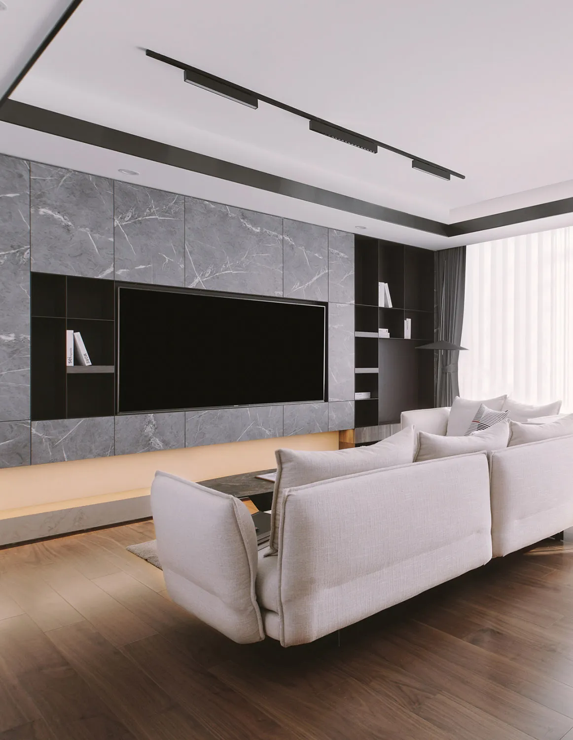 Minimalist living room with marble accent wall and concrete floor