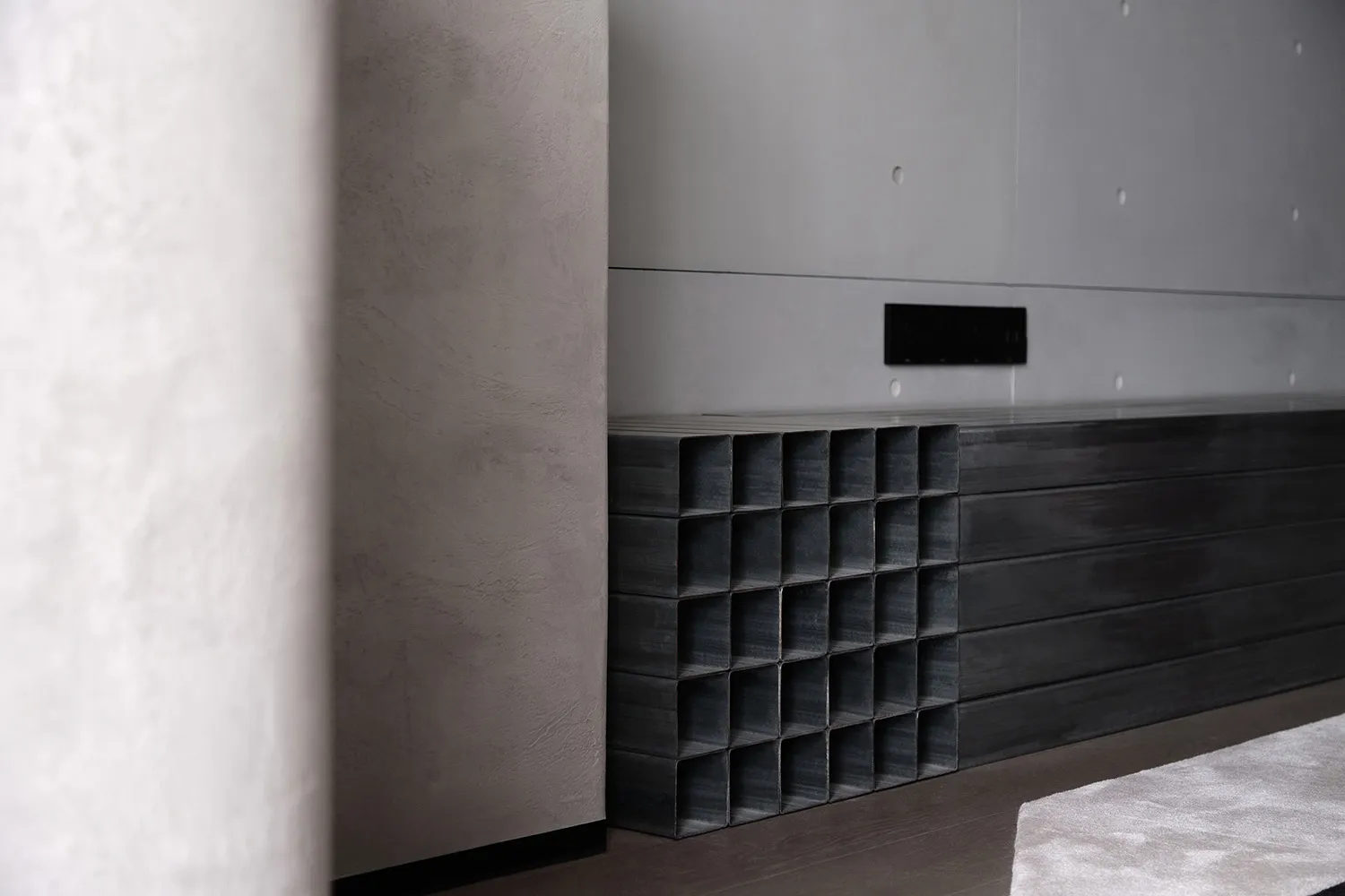 Minimalist design featuring metal panels in a modern interior setting.
