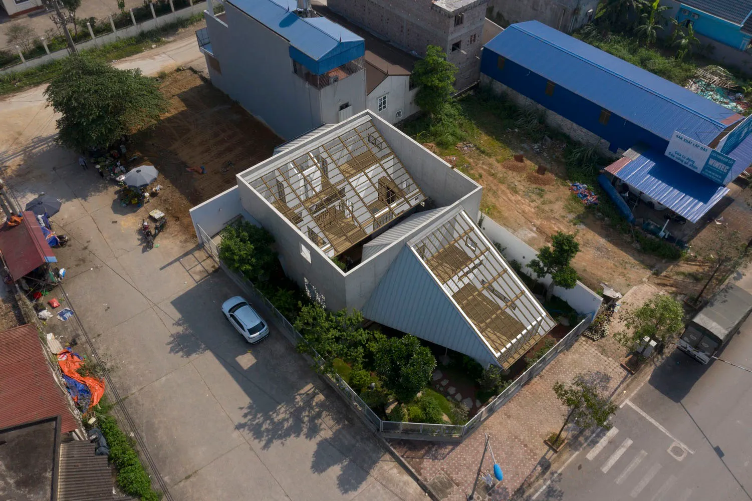 A modern building exterior constructed with concrete, glass, and aluminum materials.