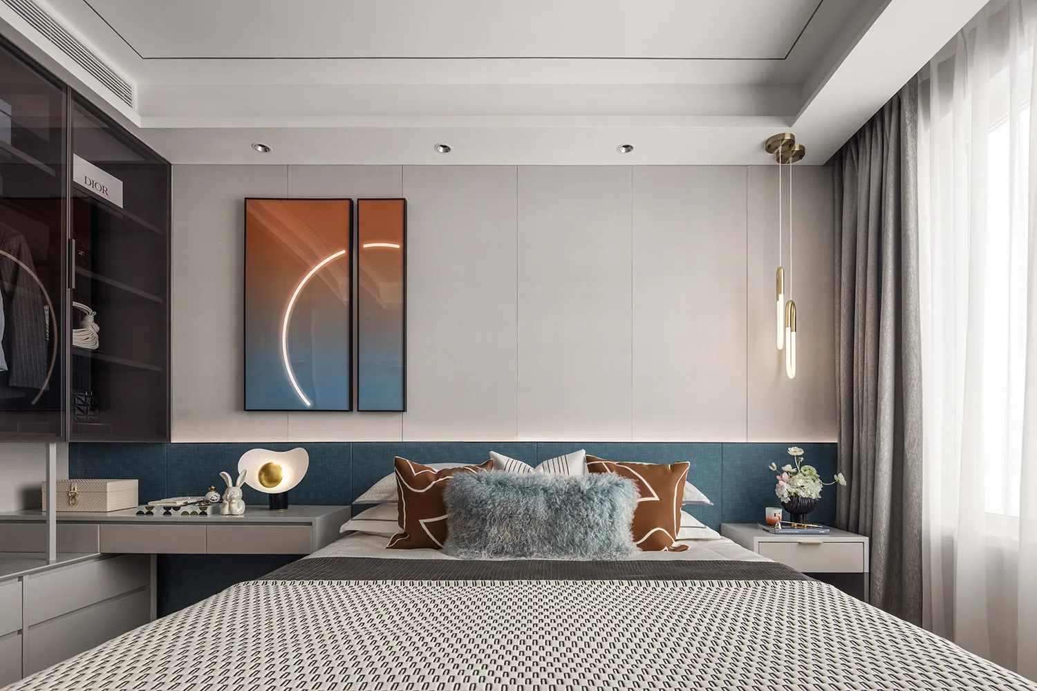 A modern bedroom featuring soft textured fabric bedding against a sleek metal and glass headboard, with a geometric pattern o