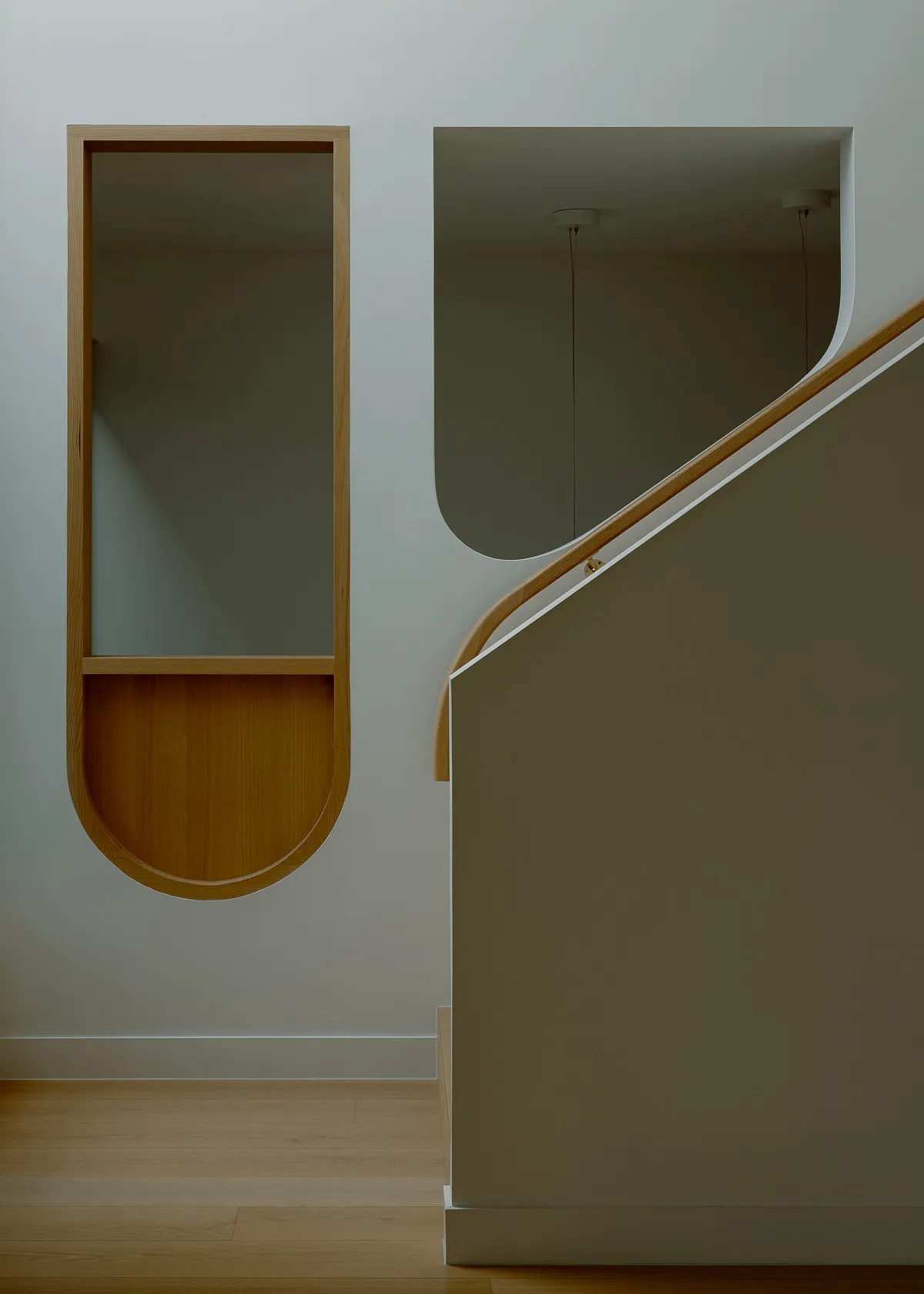 Modern interior staircase featuring wooden cladding and a minimalist design