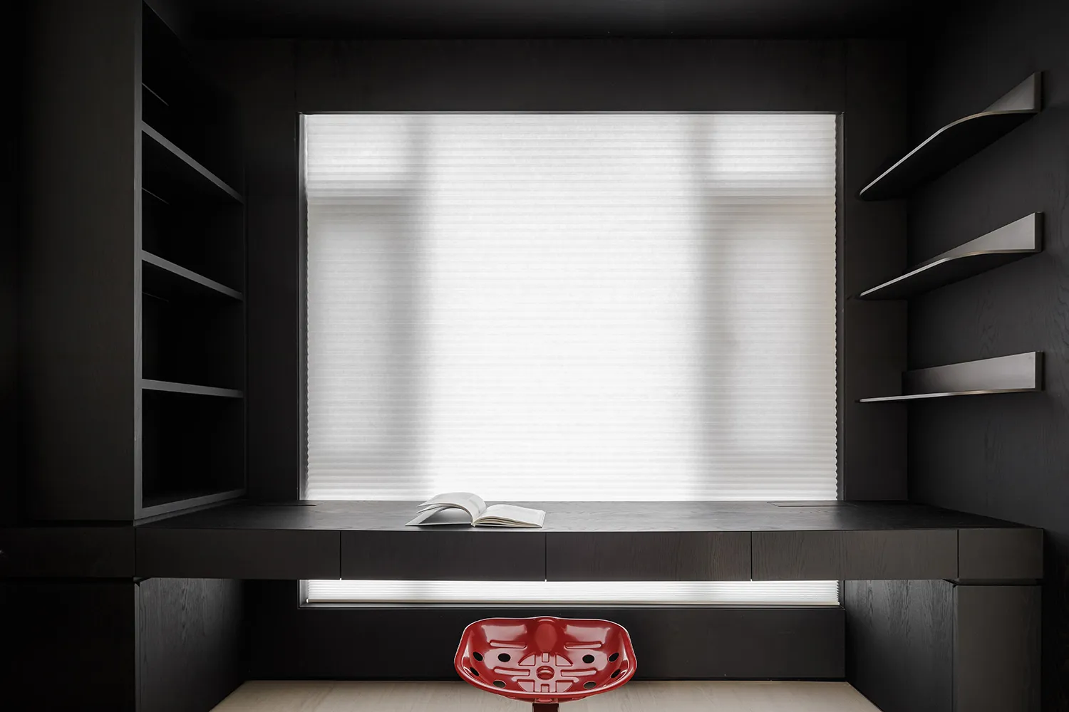 Modern workspace featuring black metallic shelves and minimalist design.